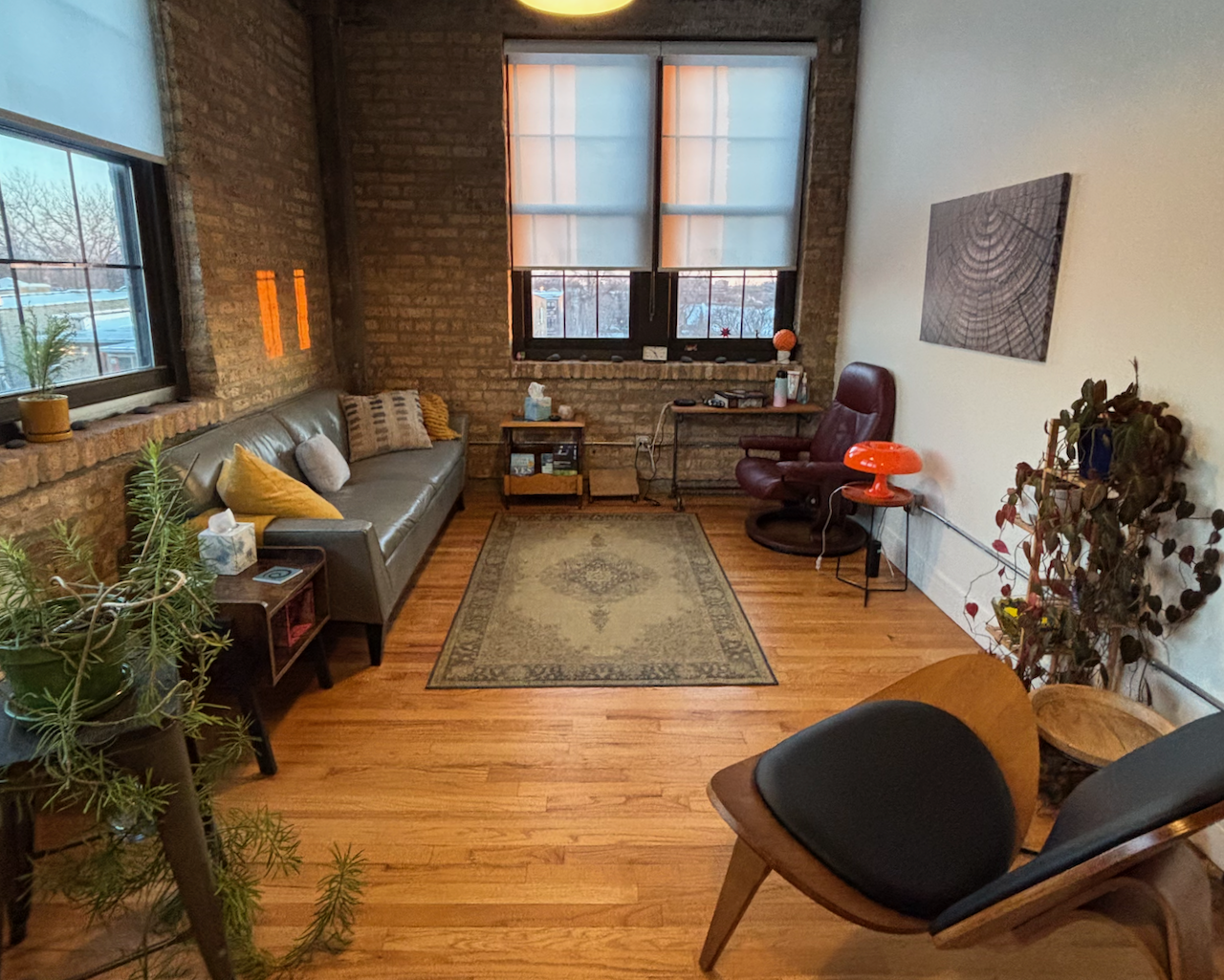 A wide angle view of Annabeth's office at golden hour, with orange reflections showing through the windows